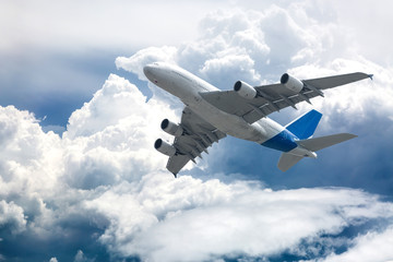  Big four engine plane on the sky with clouds. Aircraft on long intercontinental flights.