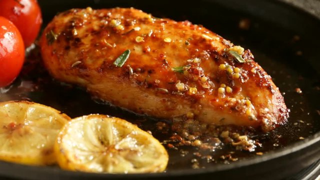 cooking fried roasted chicken breasts with lemon tomato and  rosemary mustard seeds honey