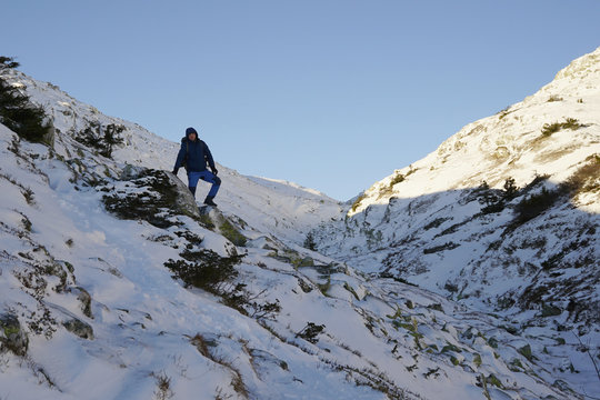 Man with backpack hiking in mountains.