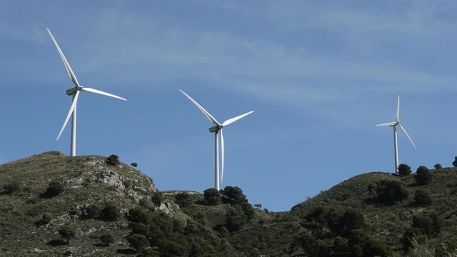 Wind turbines renewable energy moving in the mountain