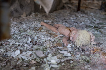 Abandoned kindergarten in Chernobyl Exclusion Zone. Lost toys, A broken doll. Atmosphere of fear and loneliness. Ukraine, ghost town Pripyat.