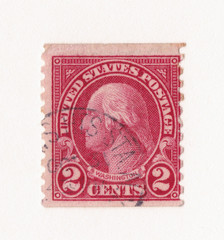 An old red vintage american postage stamp with the image of George Washington