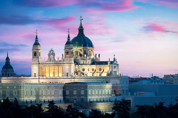 Naklejka premium Madrid landmark at night. Landscape of Santa Maria la Real de La Almudena Cathedral and the Royal Palace. Beautiful skyline at Madrid, Spain.