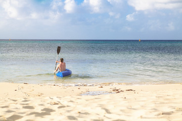 Man on Kayak on Peaceful Beach