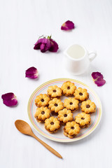 Pineapple cookies on white dish and wooden spoon