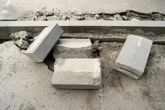 Concrete curb installation. Sidewalk asphalt renewal. Road infrastructure repair.