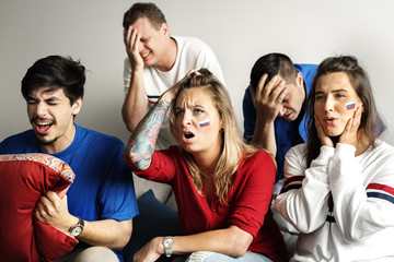 Friends cheering world cup with painted flag