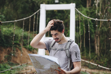 Caucasian man looking at a map travel and explore concept