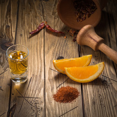 Mezcal shot mexican drink with orange slices, chili and worm salt in oaxaca mexico