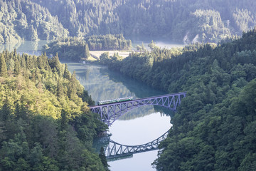 Fukushima, JAPAN - June 17 : The local train Tadami line and Tadami river on June 17 , 2017 in Fukushima , Japan. This train services in East Japan railway company's Tadami line.