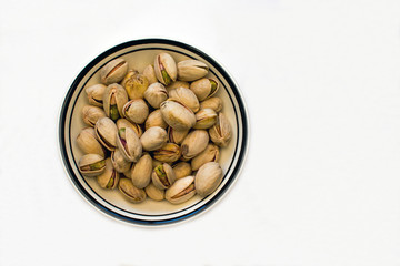 Bowl of Pistachio Nuts on a White Background
