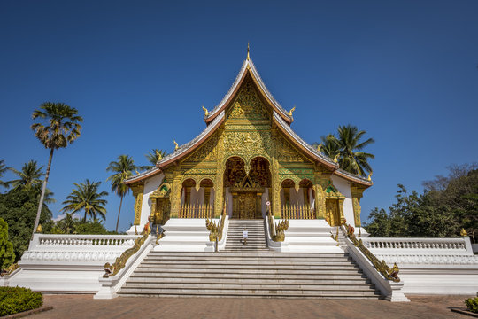 View of the temple in a blur background of surrounding trees in the courtyard of the Grand Palace of Luang Prabang in Laos
