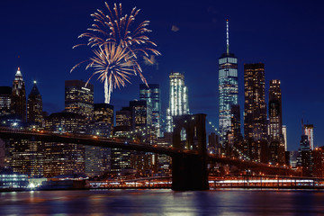 Fireworks over New York City skyline and Brooklyn Bridge