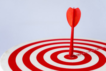 Fototapeta na wymiar Dartboard with arrow hits on target represent business achievement