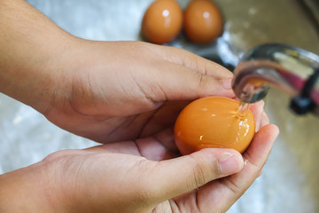 Washing eggs in a kitchen basin