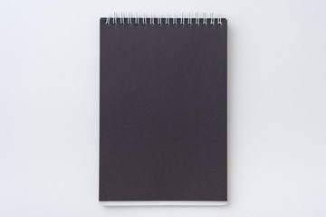 Top view of open spiral blank black notebook