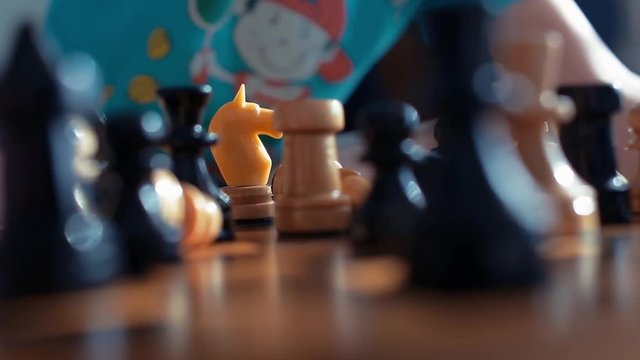 ittle boy playing chess