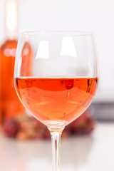 Rose wine in a glass portrait format bottle
