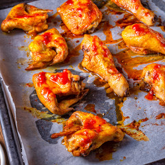 Rustic backed chicken wings,legs on baking tray