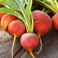 Organic golden beets on rustic wooden background