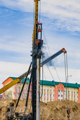 Construction machine, designed for immersion piles into the ground using the hammer, the hammer...