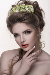 Young woman with flowers crown. Professional makeup