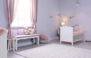 Baby room interior with comfortable crib and indoor bench