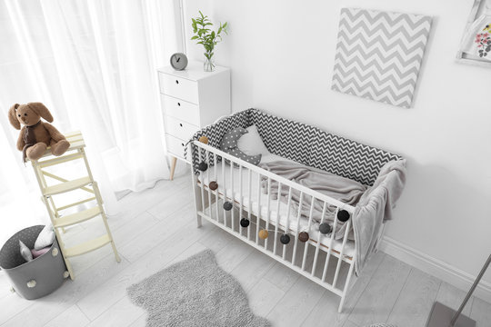 Baby room interior with comfortable crib