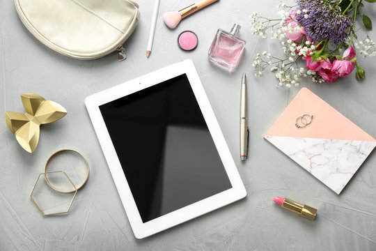 Flat lay composition with tablet and stylish accessories on light background. Blogger concept