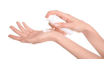 Young woman applying hand cream against on white background