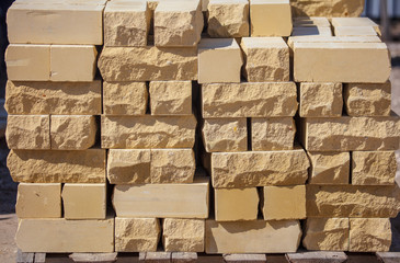 Yellow bricks on the construction site as a building material