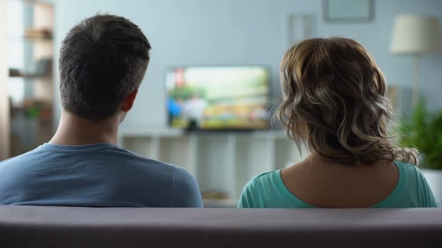Man nervously switching channels, poor quality of digital smart tv connection