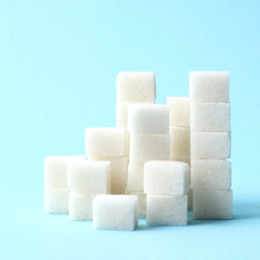  A handful of sugar cubes on a pastel background. the sugar pyramid. minimalism, design, diabetes,...