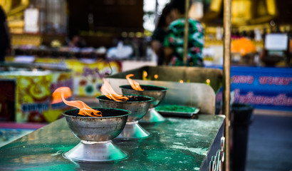 Lights in the bowls. Religious symbol of Buddhism.