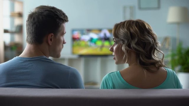 Couple arguing over watching tv, man and woman having conflict, relationship