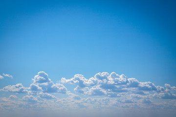 white cumulus clouds against blue sky. background