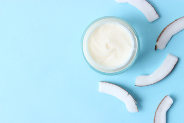  Cosmetic natural skin care products from coconut. coconut and cosmetic cream on a colored background. minimalism, the top. flatlay  
