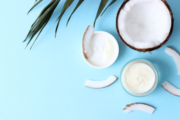  Cosmetic natural skin care products from coconut. coconut and cosmetic cream on a colored background. minimalism, the top. flatlay  