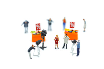 Miniature people : journalists , cameraman ,Videographer at work shooting on Shoppers with discount for shopping items of market street,Business Shopping concept.