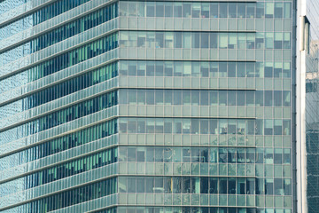 Fototapeta na wymiar Glass facade of modern city high rise buildings