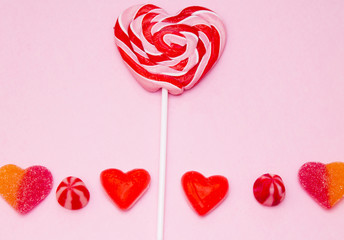 heart lollipop with heart candies on colorful background