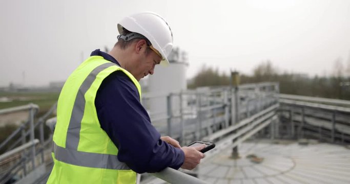 Industrial worker using a digital tablet on site