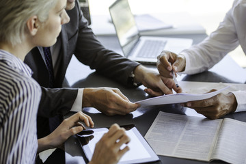 Businessman explaining document to colleagues