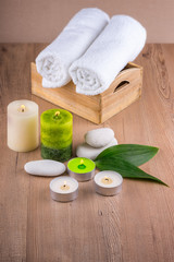 Spa decoration with candles, towels and spa stones