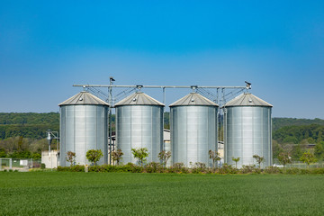 four silver silos at the field