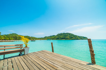 Wooden pier or bridge with tropical beach and sea in paradise island