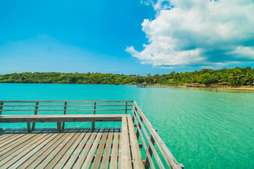 Obraz premium Wooden pier or bridge with tropical beach and sea in paradise island