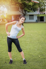 Asia beautiful woman exercising in the green garden.yoga and meditation concept.