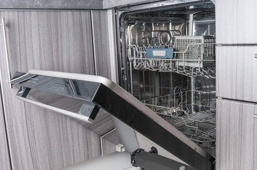 Empty dishwasher machine with opened door