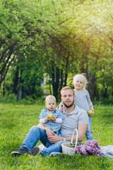 Fototapeta premium Family with two children rest in the summer garden